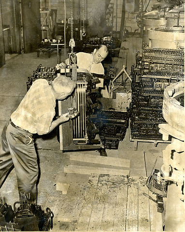 JFM062904017 - Lorain Products, men moving some machinery hanging from the ceiling..jpg