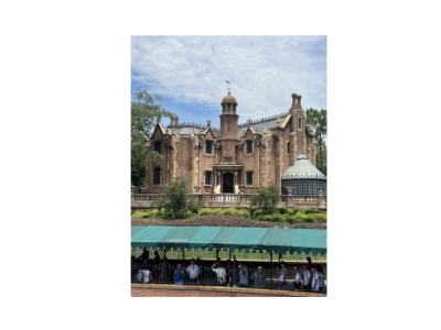 A large, brick mansion with gothic architecture under a blue sky. People queue under a green awning. The scene is calm and orderly.