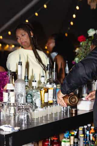 Professional bartender serving handcrafted cocktails at a luxury custom bar during an exclusive Hamptons private event designed by Blueprint Events Co. NY.
