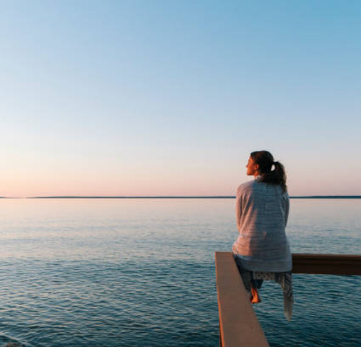 young-woman-sitting-on-edge-looks-out-at-view.jpg_s=612x612&w=0&k=20&c=zXlF6EJwCHDAtEJ_kh8