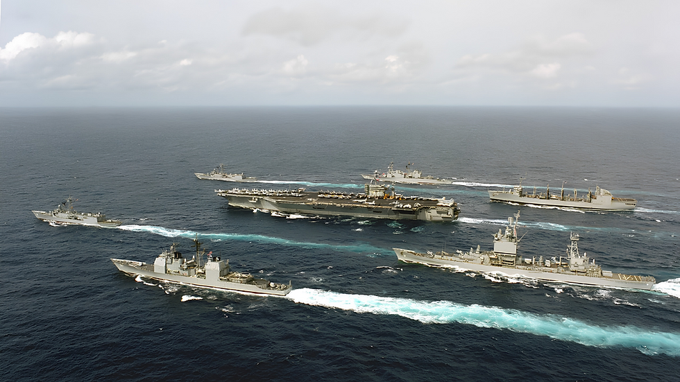 USS Abraham Lincoln sails in the Middle East after a nine-month deployment as the USS George Washington arrives to replace it. (Image Source: Wikimedia Commons)