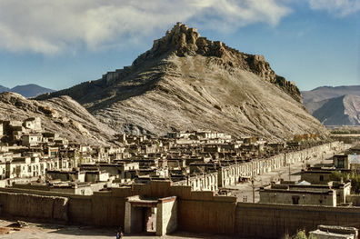 The old town of Gyantse and the fortress Gyantse Dzong on the hill. Tibet, 1987.