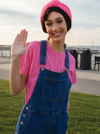 Professional preschool entertainer smiling with open hands during a birthday party.