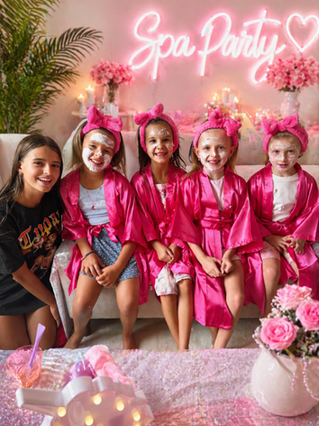 girls spa party in Northbrook IL with kids wearing pink robes and enjoying face masks at birthday party