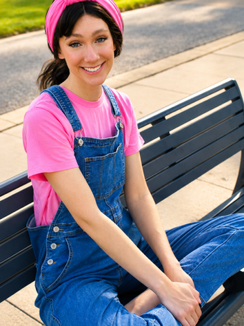 Ms. Rachel inspired children’s entertainer smiling at an outdoor birthday party.