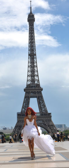 Paradise Rodriguez-Bordeaux in a one-of-a-kind white tulle high-low ball gown by Beth Anne Couture at the Trocadéro with the full Eiffel Tower above her in Paris — photography by Russel Webb