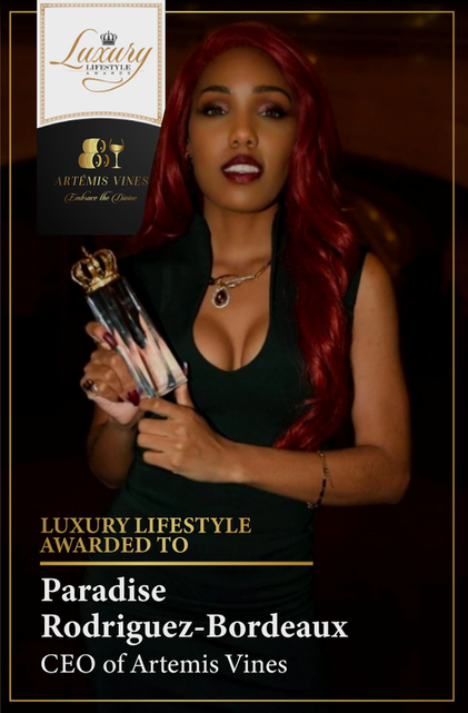 Paradise Rodriguez-Bordeaux accepting the Luxury Lifestyle Award with elegant attire and trophy.