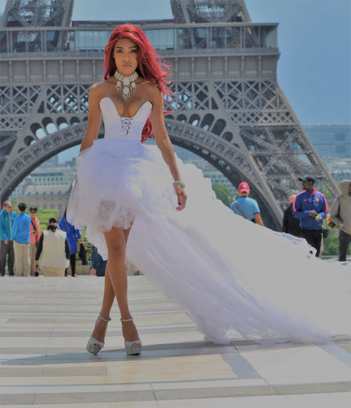 Paradise Rodriguez-Bordeaux in a one-of-a-kind white tulle high-low ball gown by Beth Anne Couture at the Trocadéro with the Eiffel Tower behind her in Paris — photography by Russel Webb