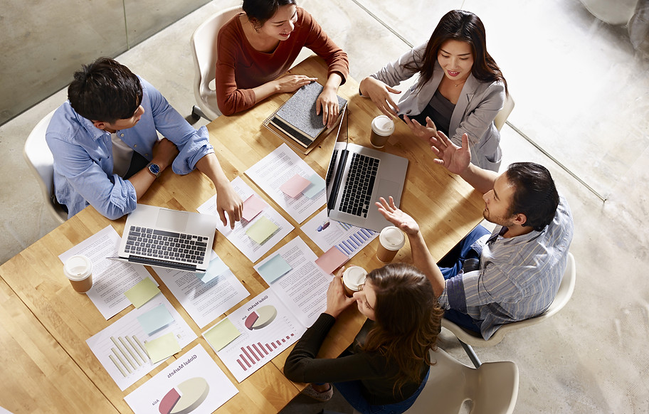 Business team reviewing documents and discussing financing options – Factoring with Goba Capital