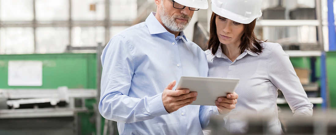 Engineers using digital tablet in steel