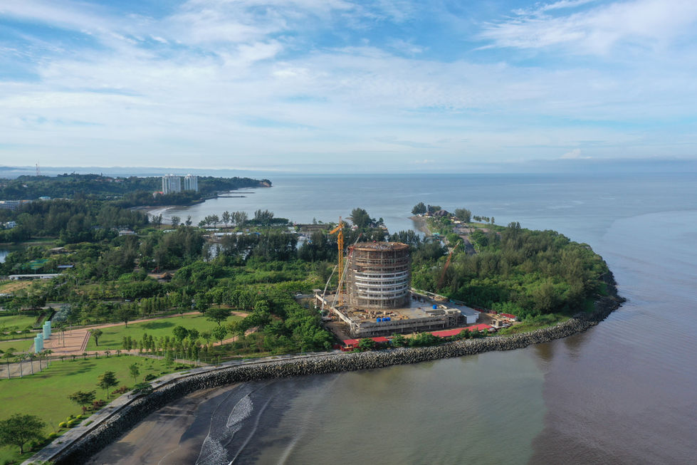 Aerial view of coastal area with greenery and buildings, Miri City Council Construction