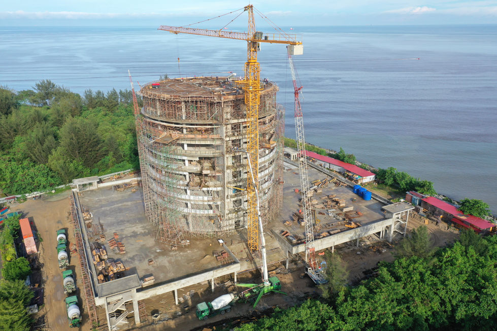 Construction site with crane near water and greenery Miri City Council Construction
