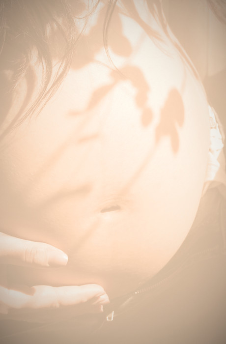 Mother holding her pregnant bump