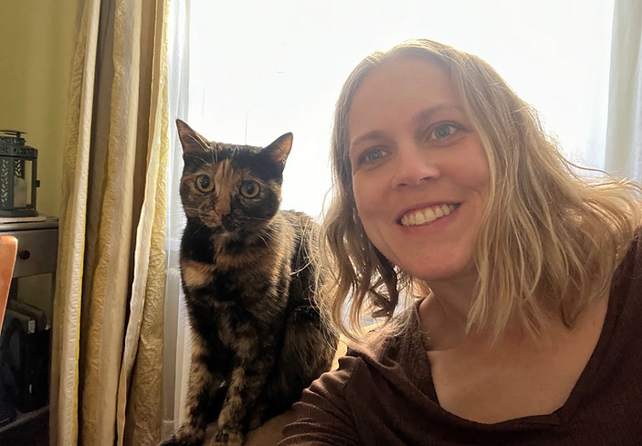 Rose with a cat friend that lives in another country she visited