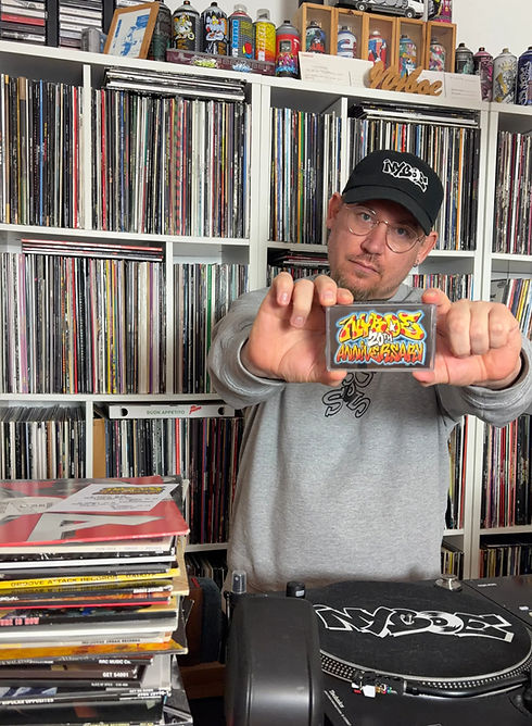 Nyboe holding his 20th anniversary mixtape cassette tape