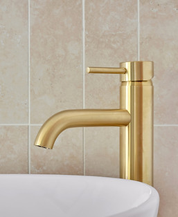 Polished brass tap tile splash back