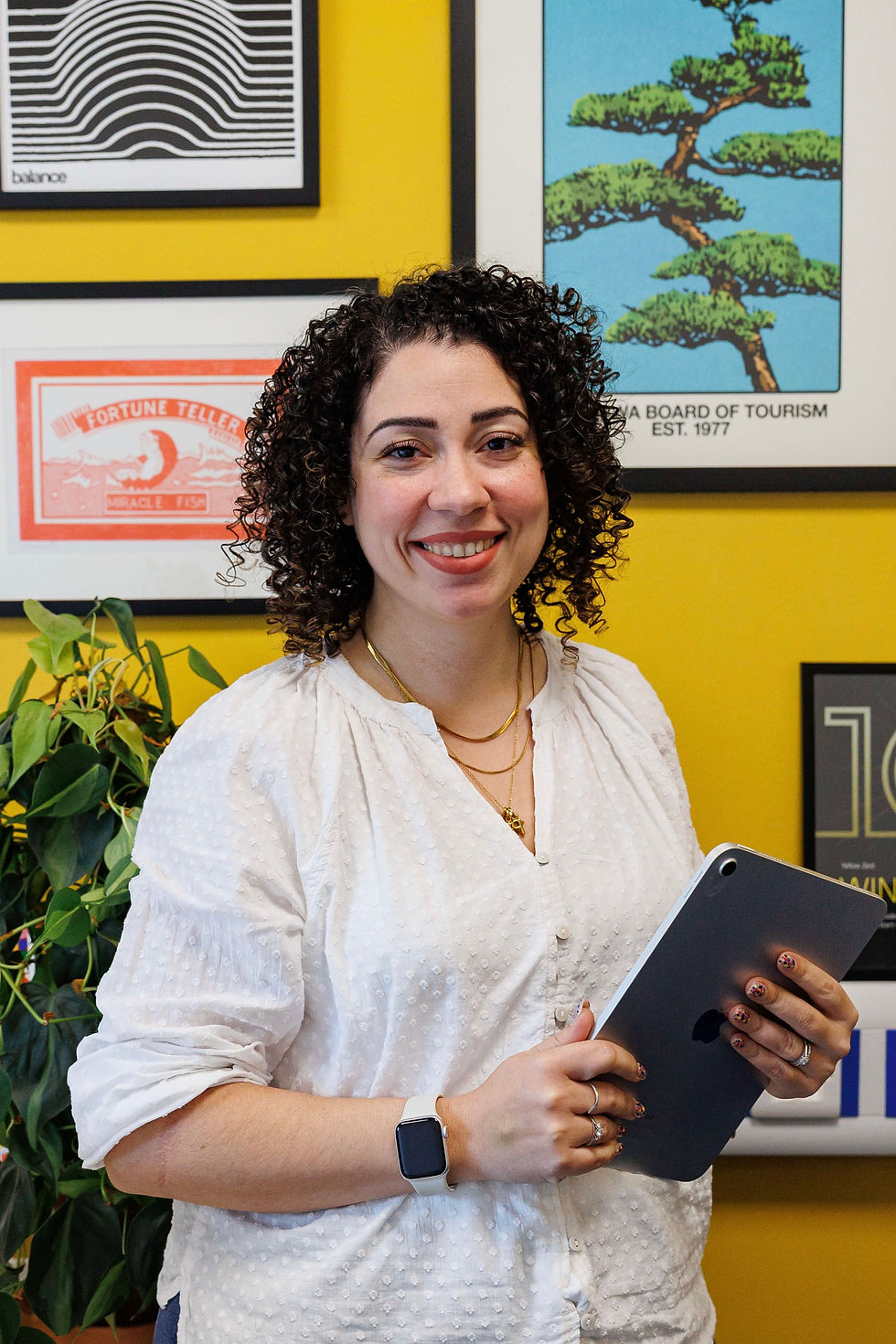 woman standing holding an ipad in office