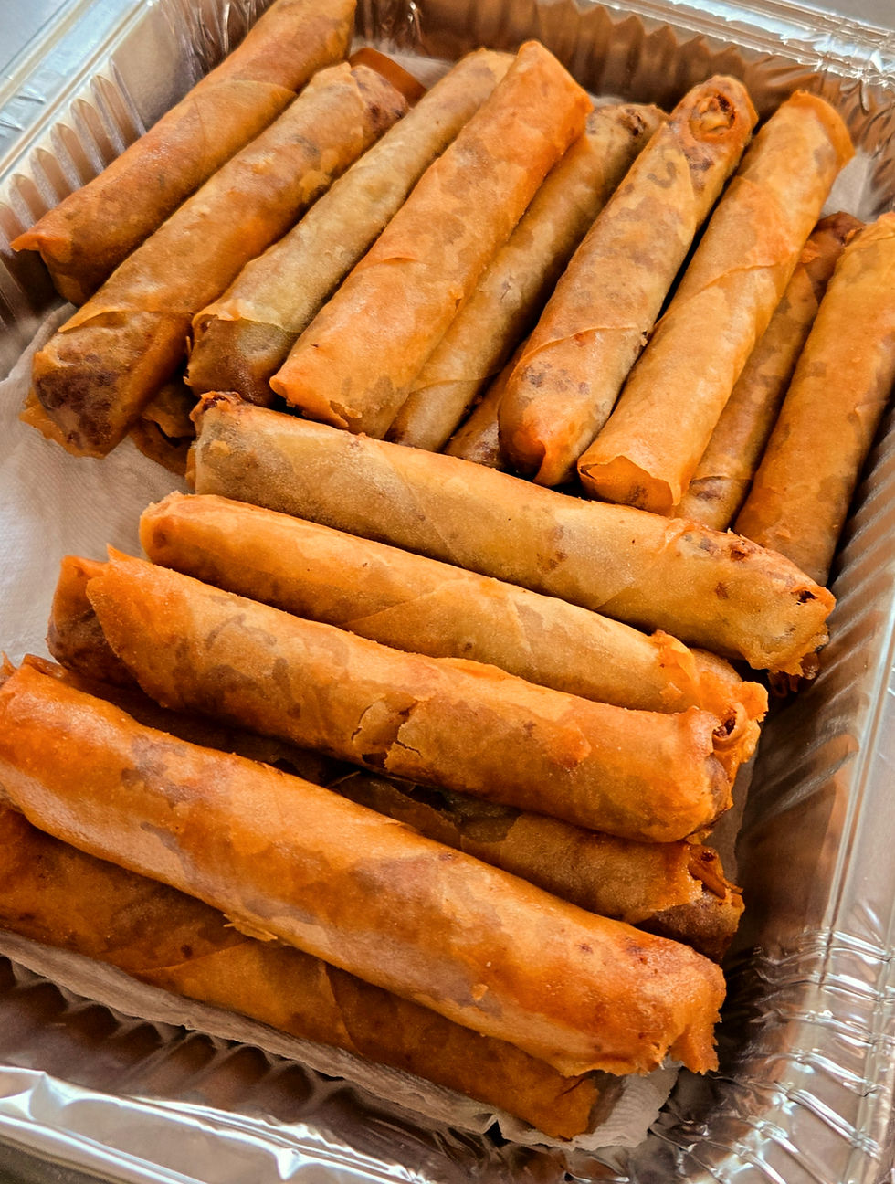 Crispy spring rolls from a Rochester food truck in a tray.