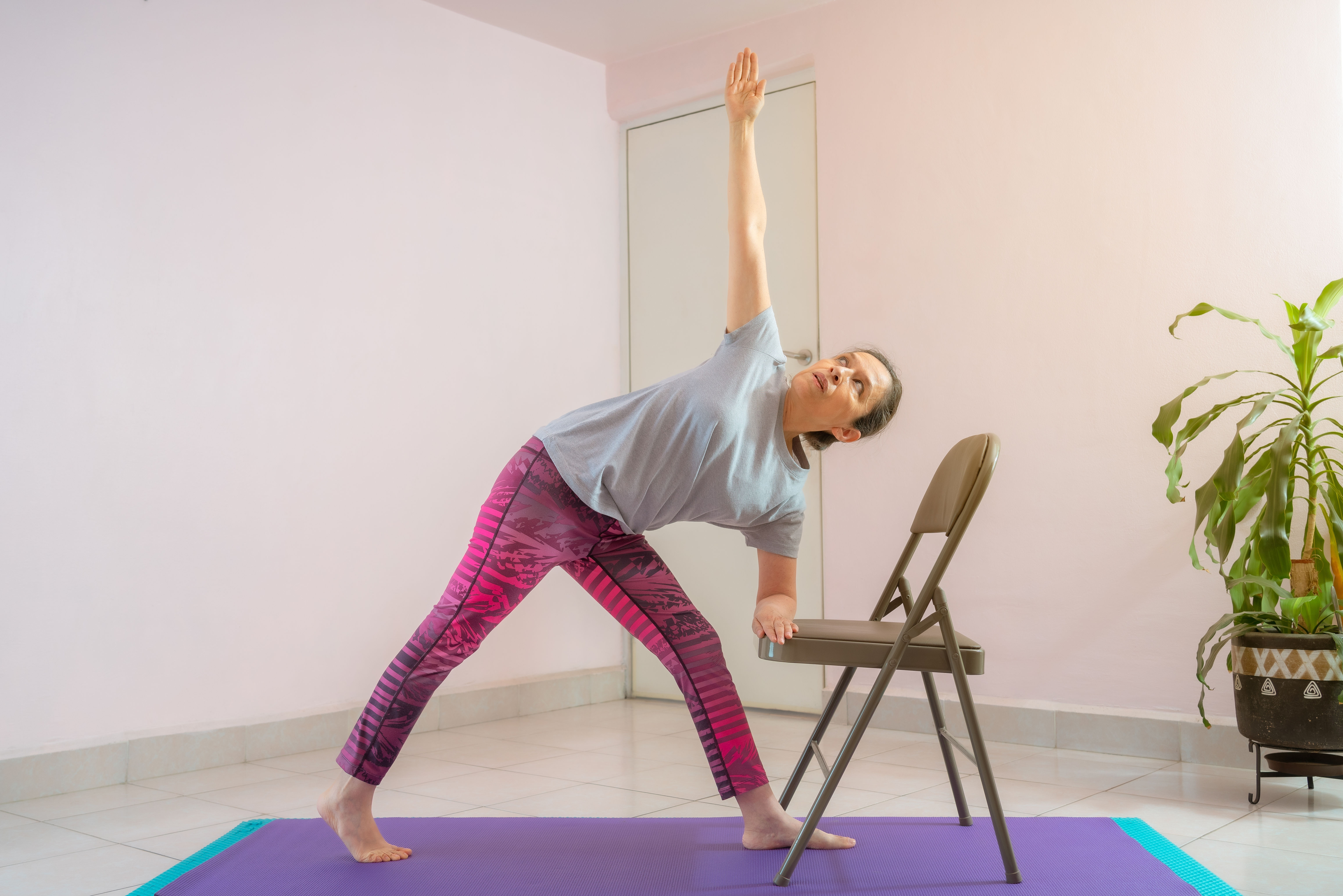 Group of people practice yoga in a studio. Flow Yoga class exercise.