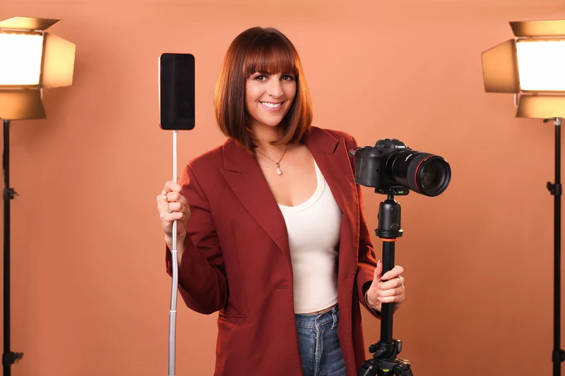Person holding gear for videography and photography