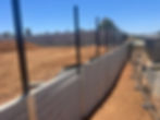 Commercial construction project: concrete fence installation.