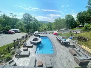 Textured concrete pool deck with non-slip surface around swimming pool in Pittsburgh backyard