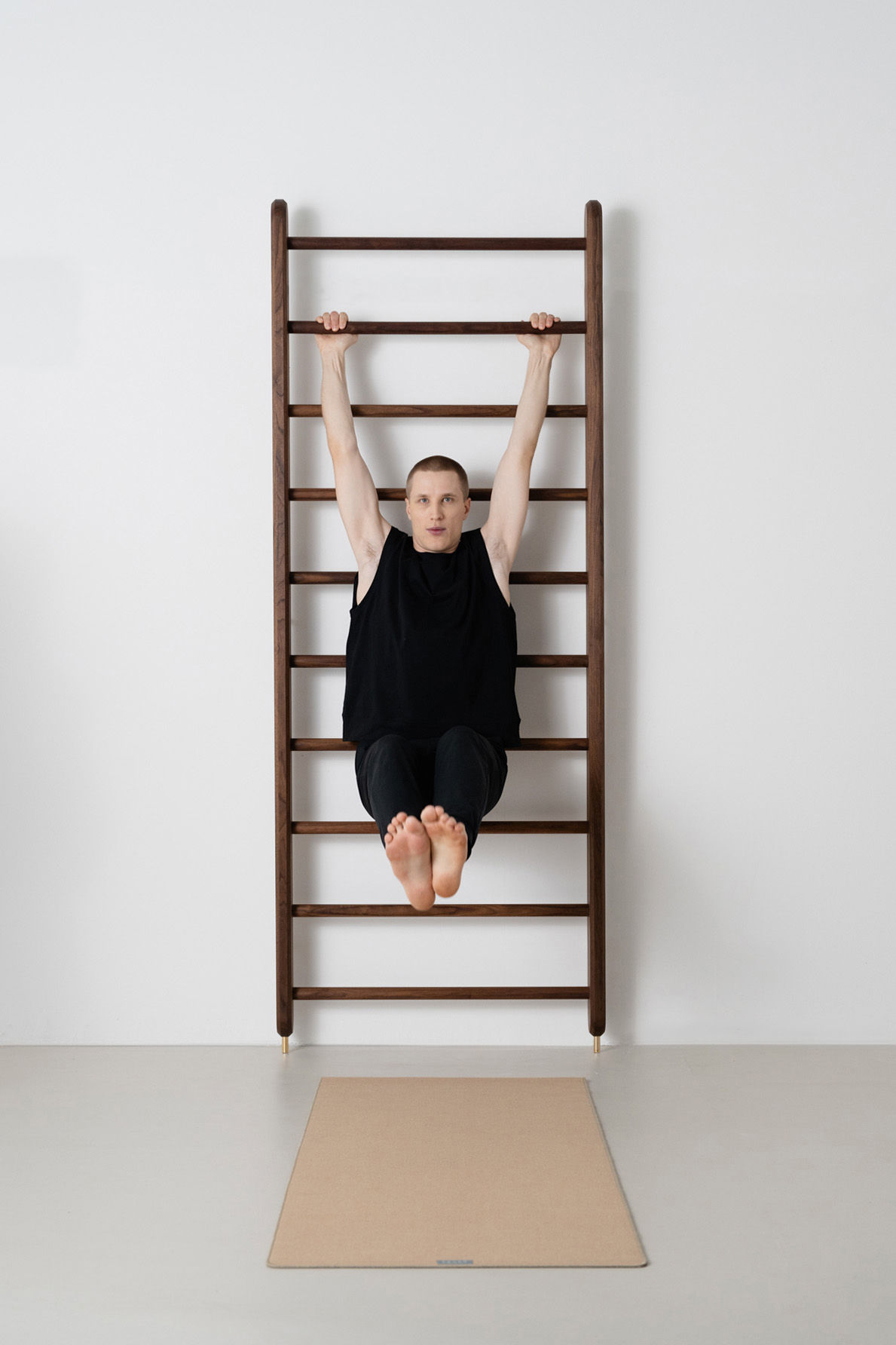 Mann trainiert an Sprossenwand Wall Bar aus Walnuss