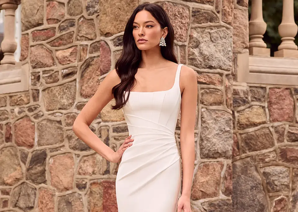 Paloma Blanca 5183
Fit and flare, satin gown. Square neckline, ruching and a tulle back with exposed boning and covered buttons.