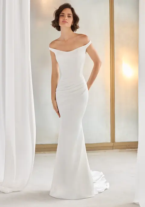 5211 by Paloma Blanca. Stunning charmeuse fit and flare gown with ruching and off the shoulder neck line.