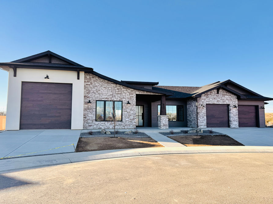 Three Raynor AP138 garage doors in Cocoa Hickory.