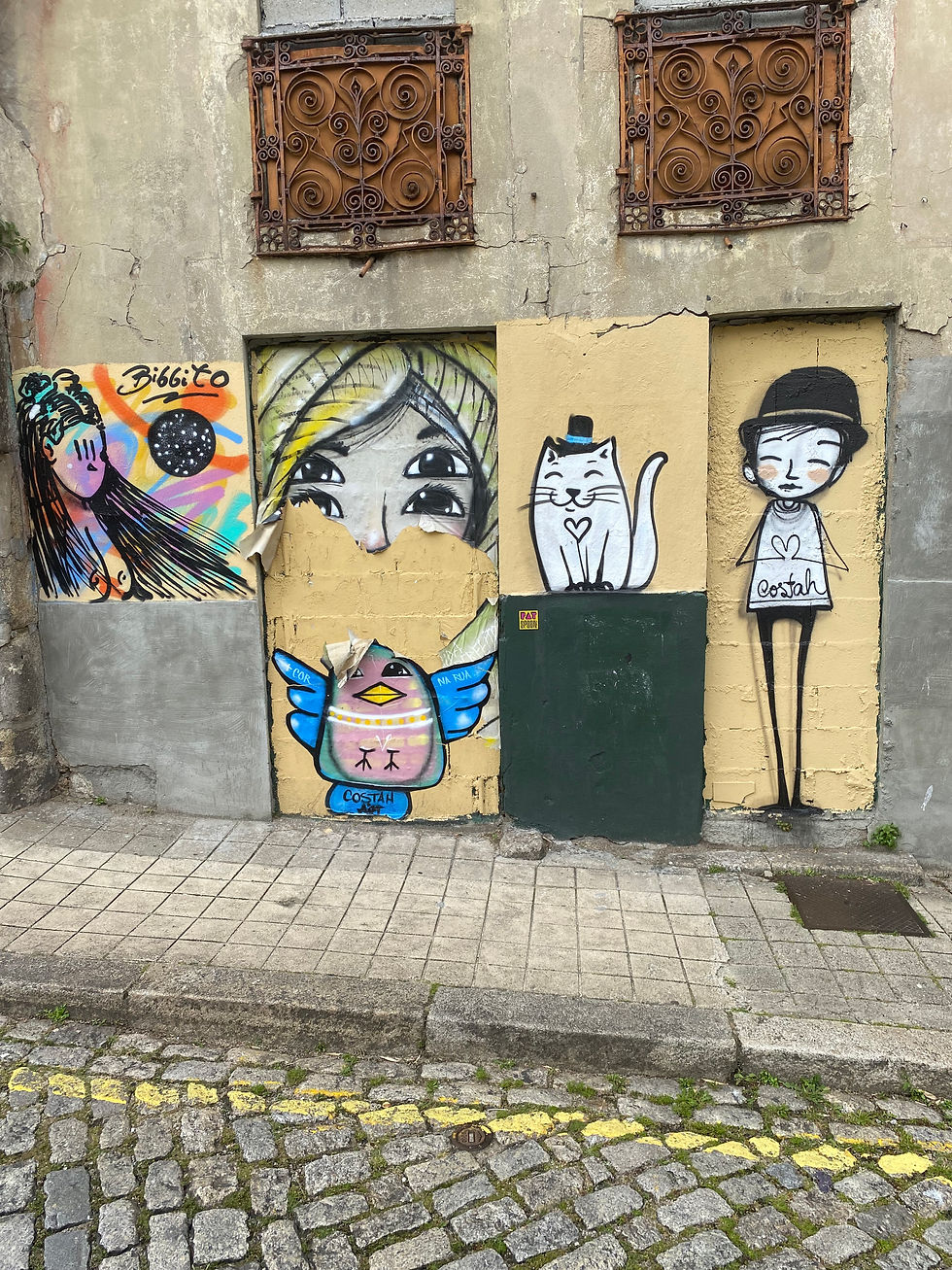 drawings of different characters on a wall in porto portugal