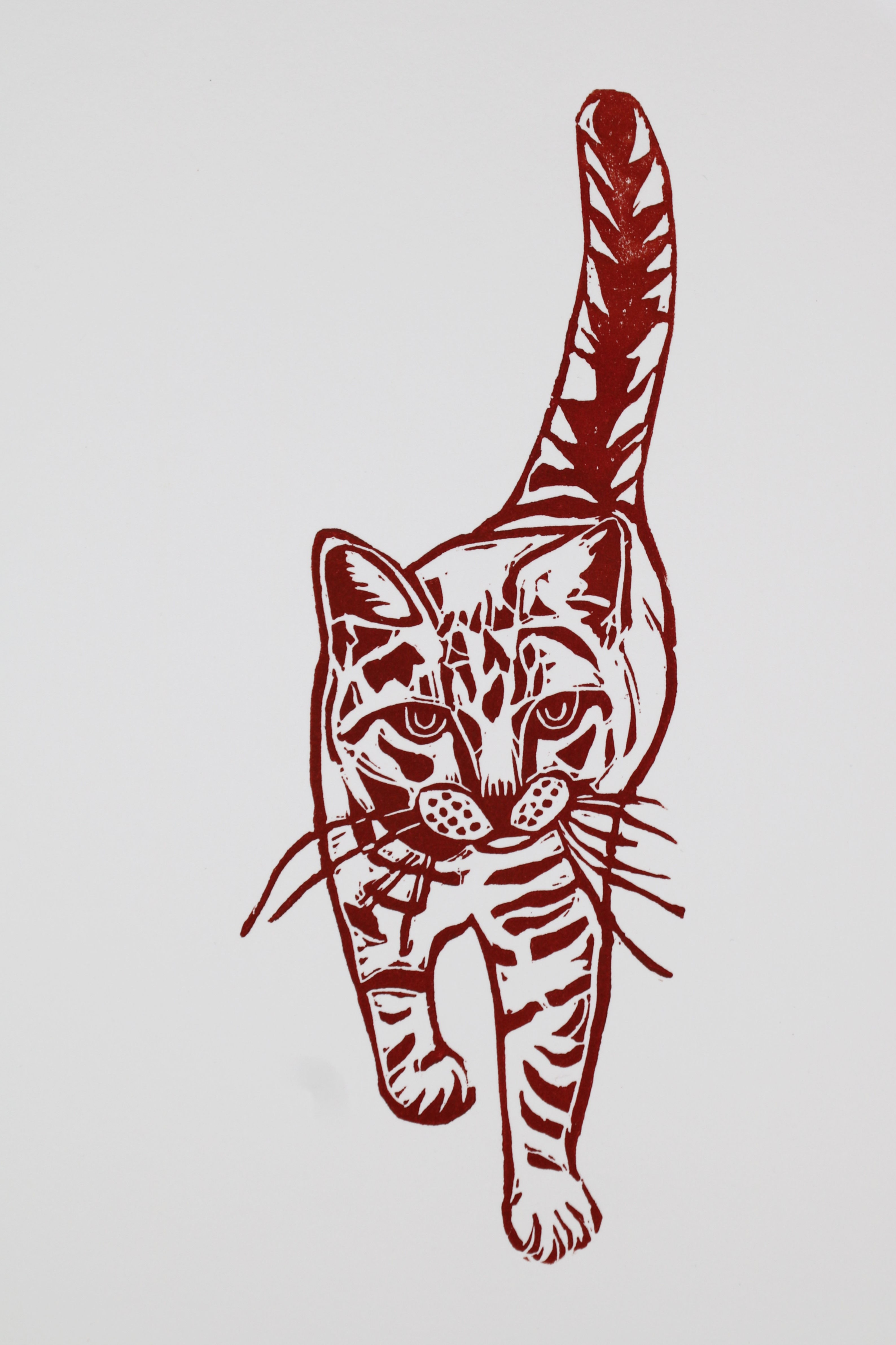 "Fishy Cat Strut" ginger cat walking linocut print in dark orange ink by Deborah Vass