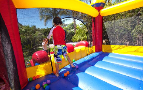 Child playing in colorful bouncy castle