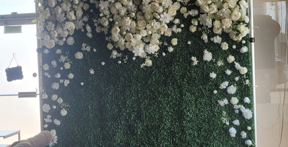 Greenery flower wall backdrop with white flowers for event photos.