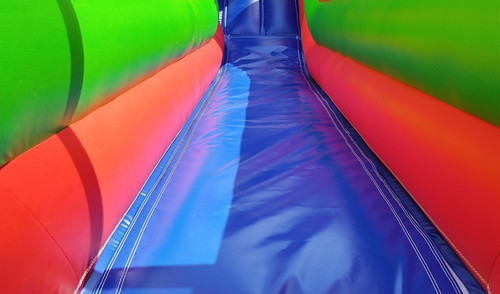 Obstacle course with a big slide rental, colorful interior