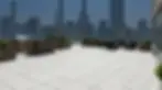 Commercial power washing company cleaning a luxury rooftop patio terrace with the Manhattan New York City skyline background.
