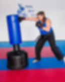 Eye-level view of a person practicing martial arts stance in a training room