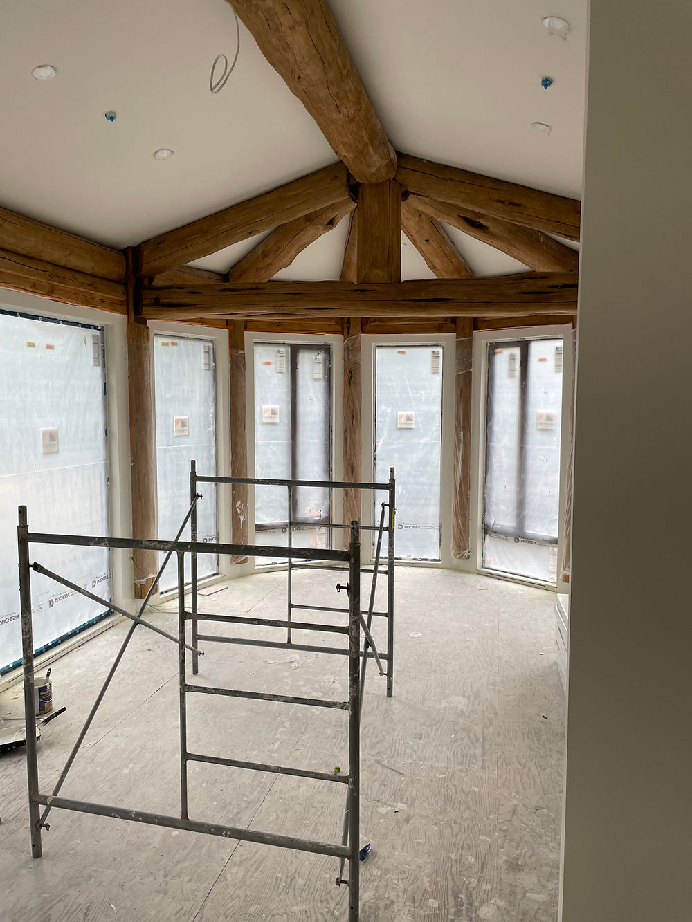 New room construction with scaffolding for painting