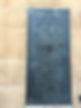 Image of an engraved commemorative metal street plaque showing a face and poem.