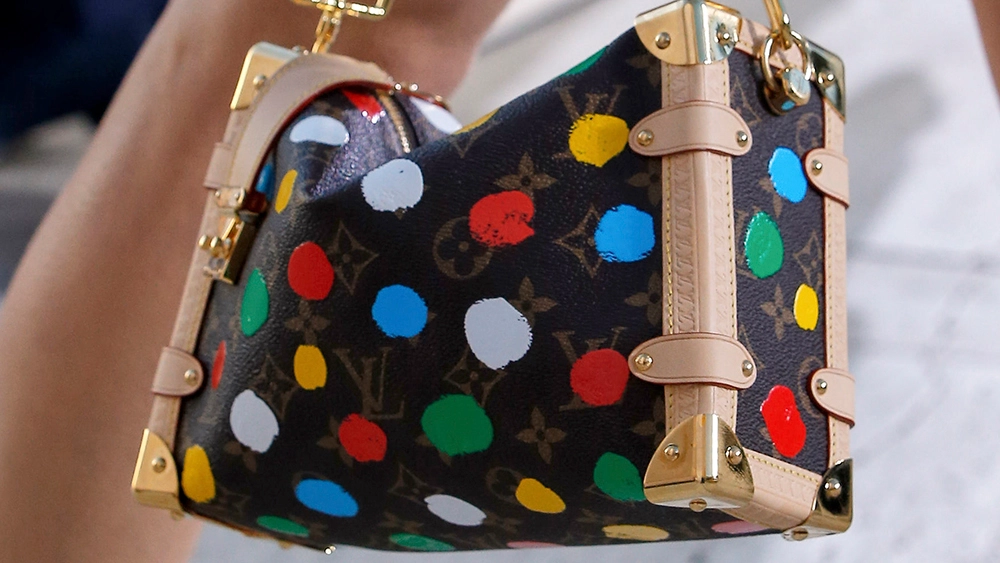A close up of an LV monogrammed bag with coloured polka dots