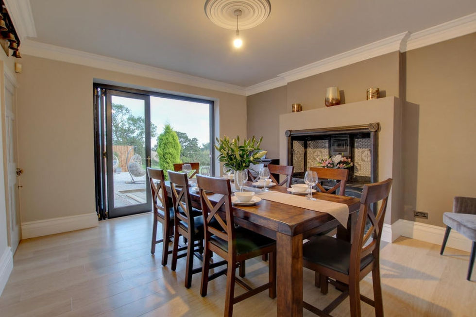 a dining room with a table and chairs and a fireplace