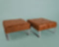 Two brown Falx ottomans with steel legs
