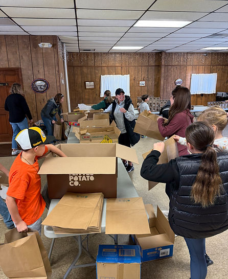 Volunteers packing boxes and brown bags at our Storehouses in Pittsburgh