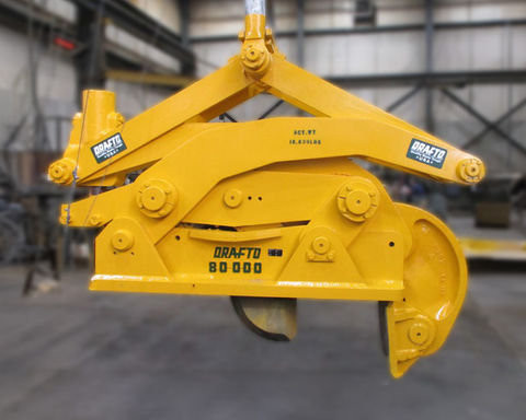 Yellow industrial lifting clamp with "Drafto 80000" text in factory.