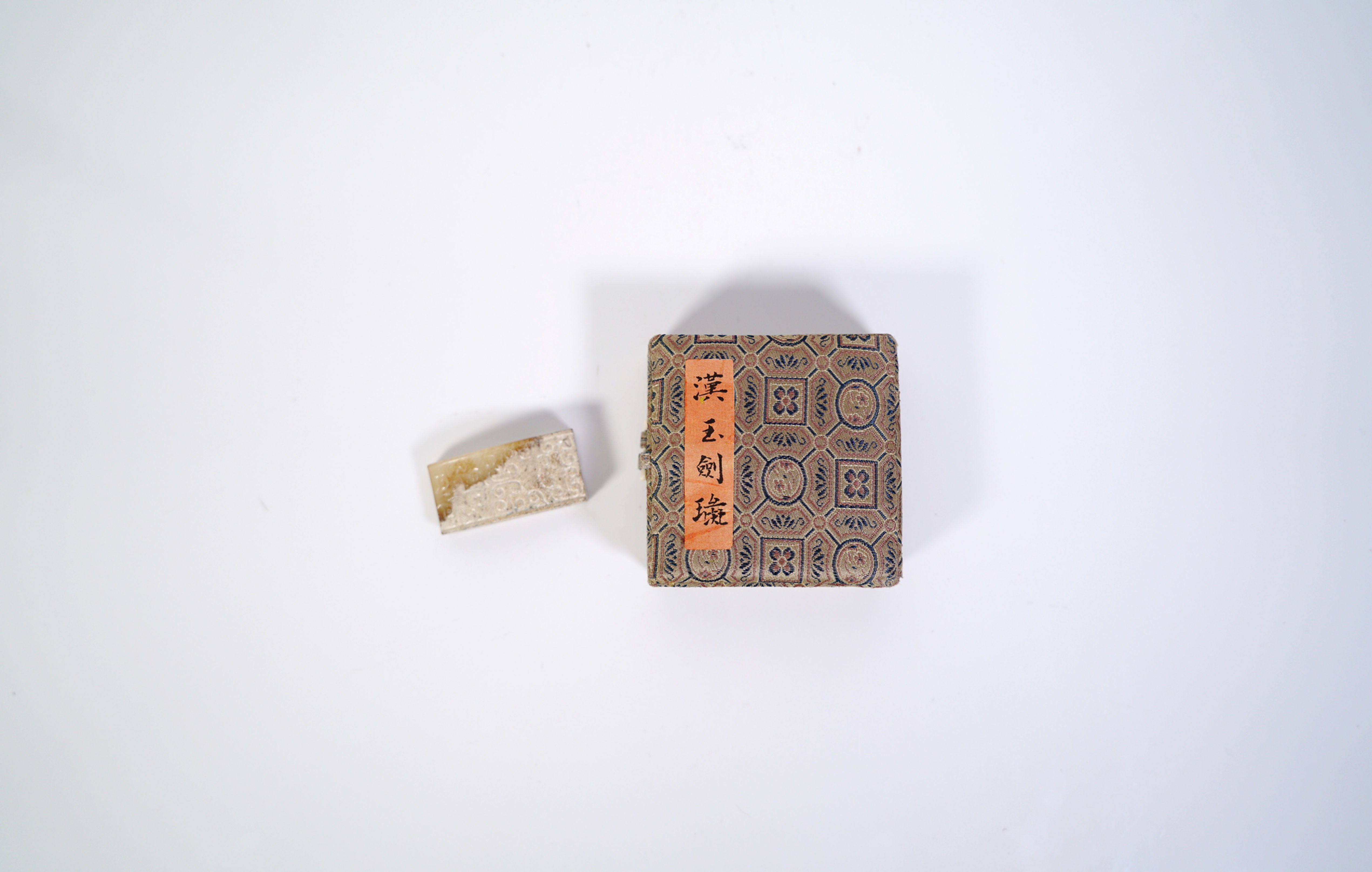 An Altered Jade Sword Slide and a Box