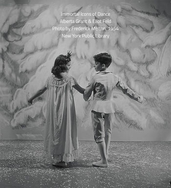 Two young children dressed in ballet costumes walk away from the viewer towards a painted winter landscape backgdrop