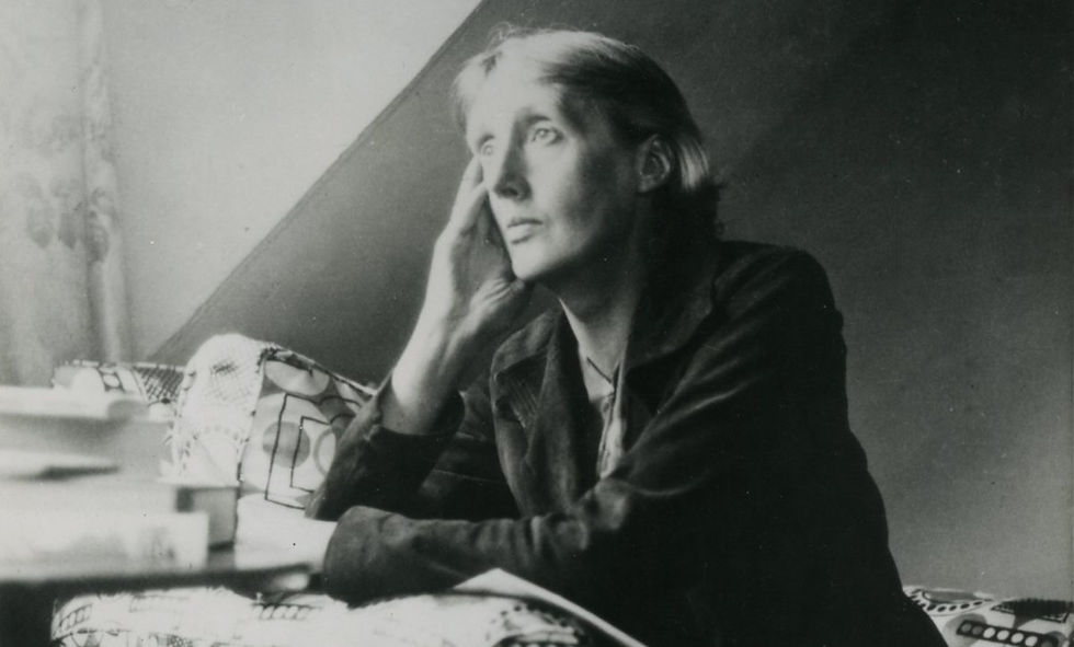 The modernist writer Virginia Woolf seen writing next to a window