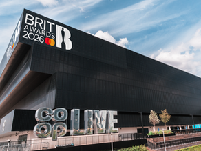 The Co-Op live arena with the BRIT award logo displayed on the top wall and a mirror clad Co-Op Live freestanding logo towards the bottom of the image.