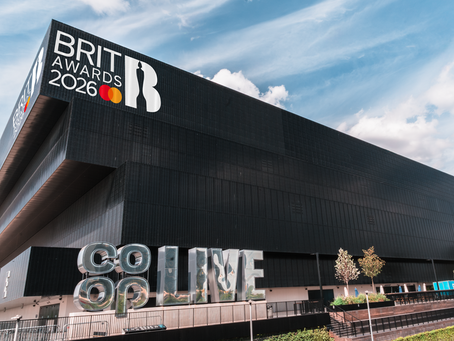 The Co-Op live arena with the BRIT award logo displayed on the top wall and a mirror clad Co-Op Live freestanding logo towards the bottom of the image.