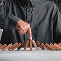 finger-of-businessman-pointing-one-wooden-to-stopp-2025-03-06-10-45-25-utc.jpg